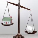 Law scales with house model and piggy bank on table background. 