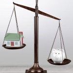 Law scales with house model and piggy bank on table background.