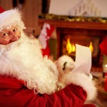 Santa Claus enjoy in warm home near the fireplace and reading wish list