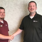 New Richmond Branch Manager Tyler Webb shakes hands with the outgoing Branch Manager Jason Burdette who has accepted the job of VP of Member Services.